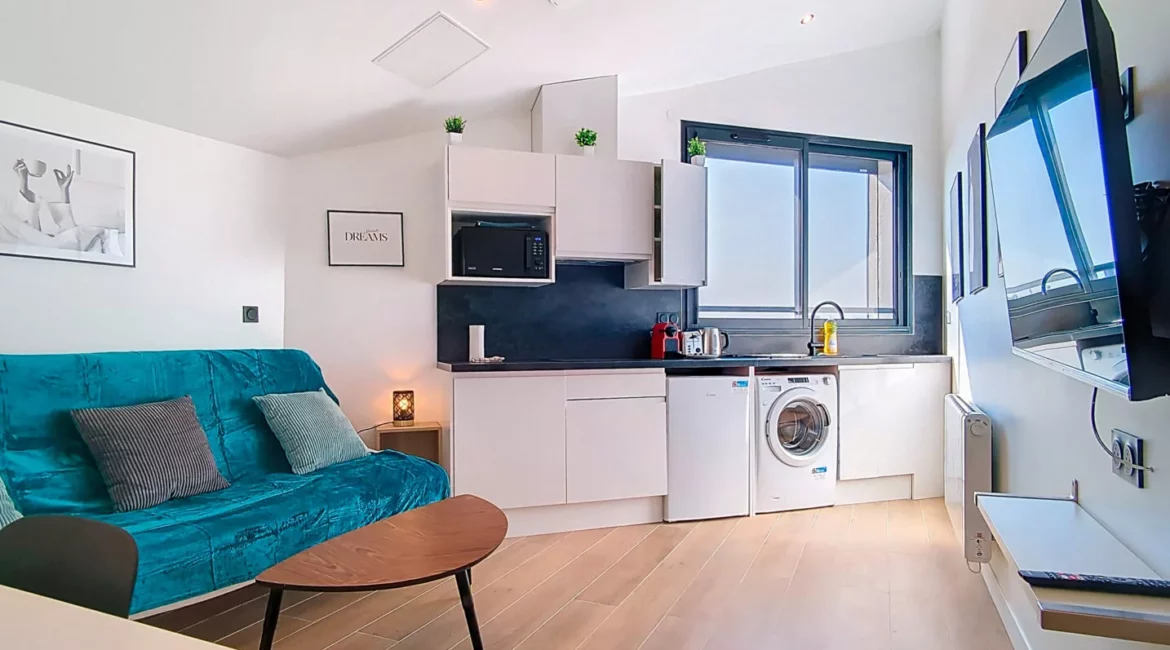 canape lit cuisine equipements complets location appartement court et long sejour argenteuil Salon moderne avec canapé et cuisine équipée.