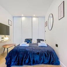Chambre moderne avec lit et décoration minimaliste.