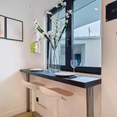 Coin-repas minimaliste avec fenêtre et décorations murales.