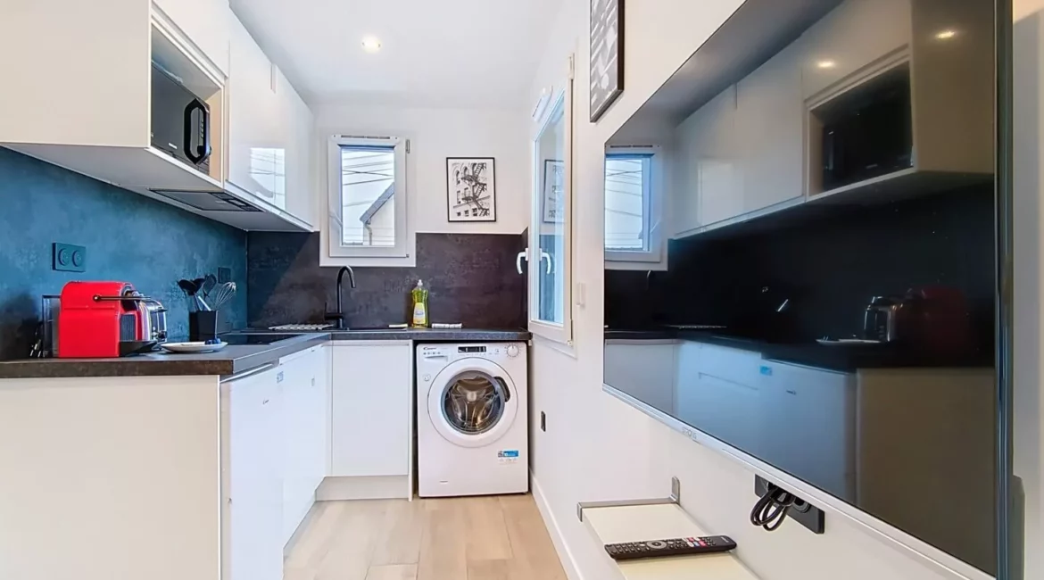 cuisine location studio voyage argenteuil Cuisine moderne avec électroménagers et télévision murale.