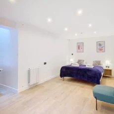 Chambre moderne avec lit double et bureau.