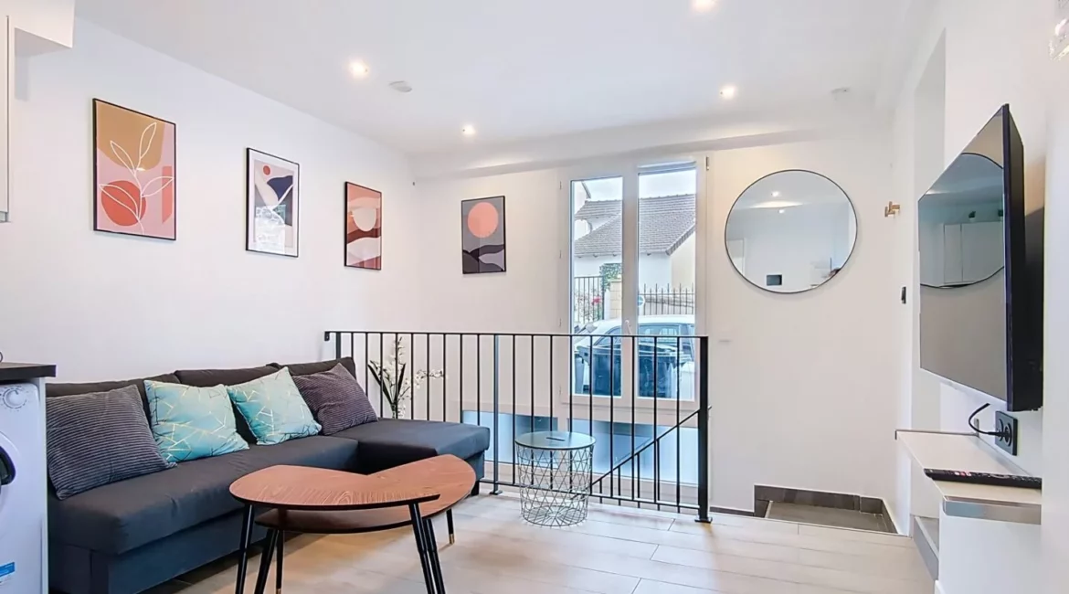 Salon moderne avec canapé et décoration murale.