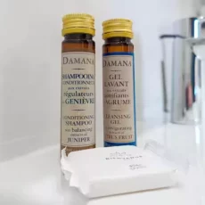 Shampoing et gel lavant Damana sur lavabo.